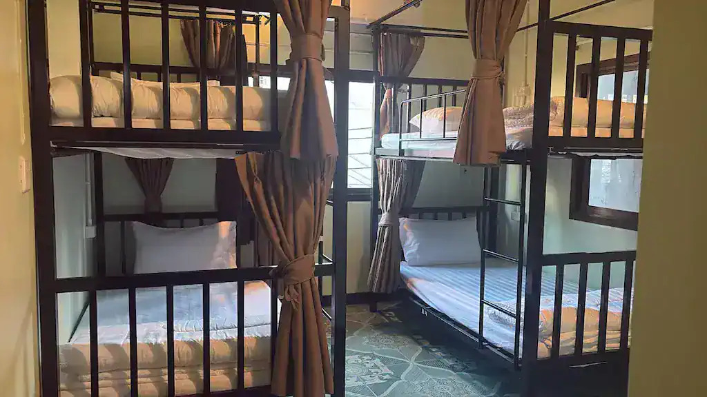 Dorm interior with wooden bunk beds at Apple House Koh Tao