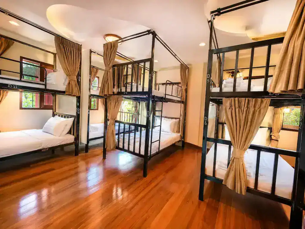Bright dorm interior with wooden bunk beds at Apple House Koh Tao