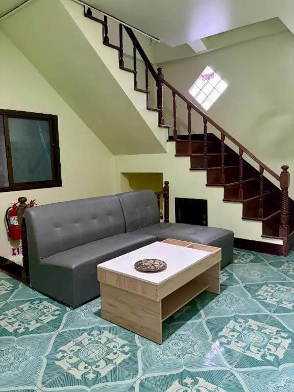 Lounge with sofa and staircase at Apple House Koh Tao