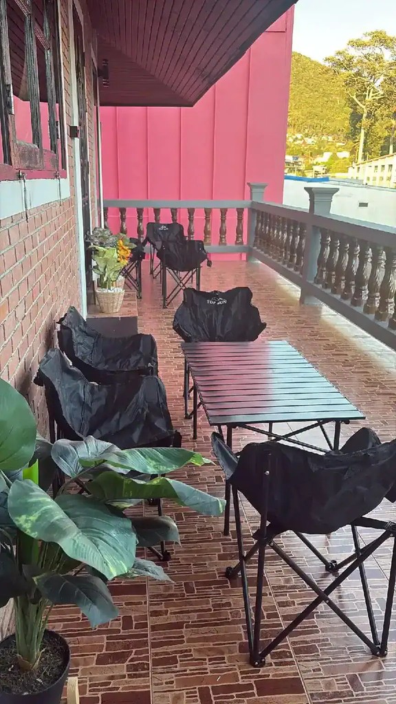 Tables and seating on the terrace at Apple House Koh Tao